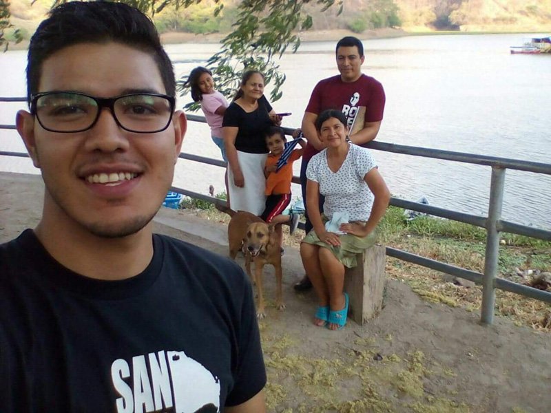 Miguel Ángel, Carmelite pre-novice taking a selfie with Brother Cecilo Hernandez, O. Carm., and a family from Santa Cruz enjoying the lake which was created to generate electricity.