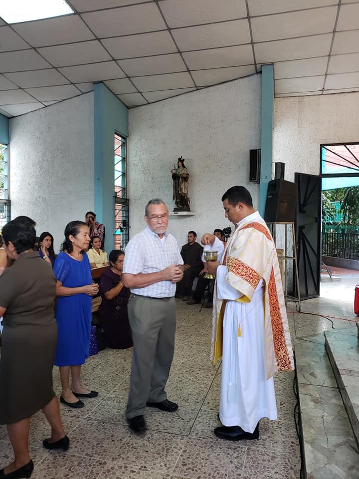 The newly ordained deacons distributes communion to the faithful who came to witness his ordination.